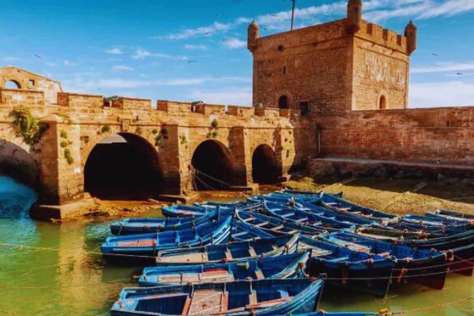 Traditional blue fishing boats docked at Essaouira’s harbor.