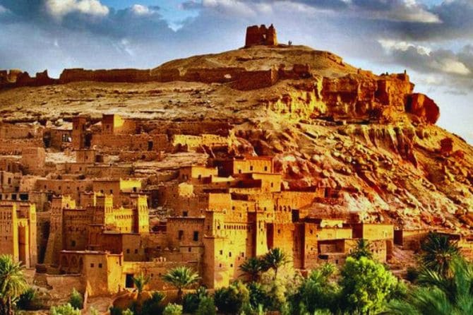 The golden hues of sunset casting a warm glow over Ait Ben Haddou.